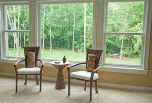 View from inside a living room with two chairs in front of a picture window
