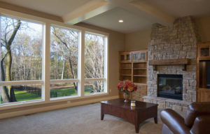 Large windows offering beautiful views of the trees outside the property.