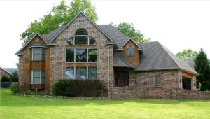 Front-facing view of a beautiful, rustic style home featuring many windows.