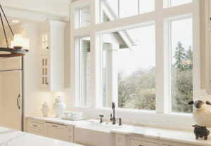 Beautiful large windows above a kitchen sink.